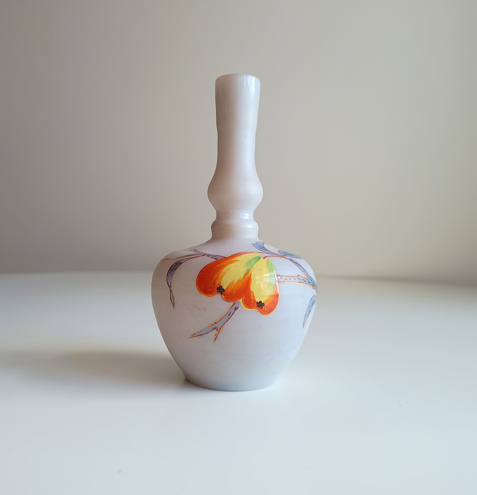 Art Nouveau coffee opaque soft glass vase has a bulbous Chinoiserie shape and a satin finish. It is hand-painted with early Art Nouveau style red and yellow flowers and grasses