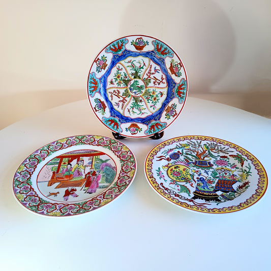 Three decorative ceramic plates with intricate designs on a white surface.