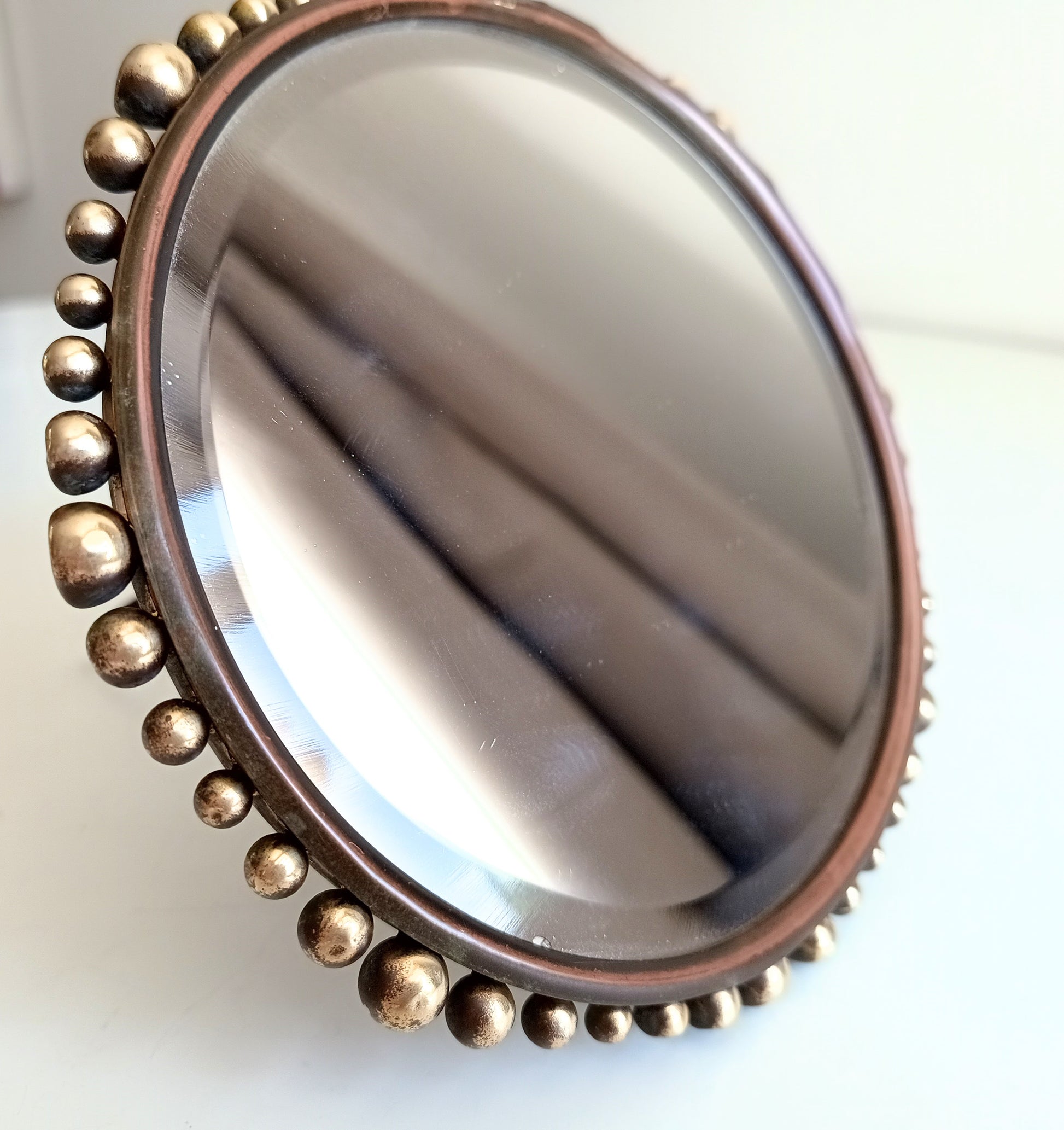 Round metallic object with a beaded border  Vereinigte Werkstätten