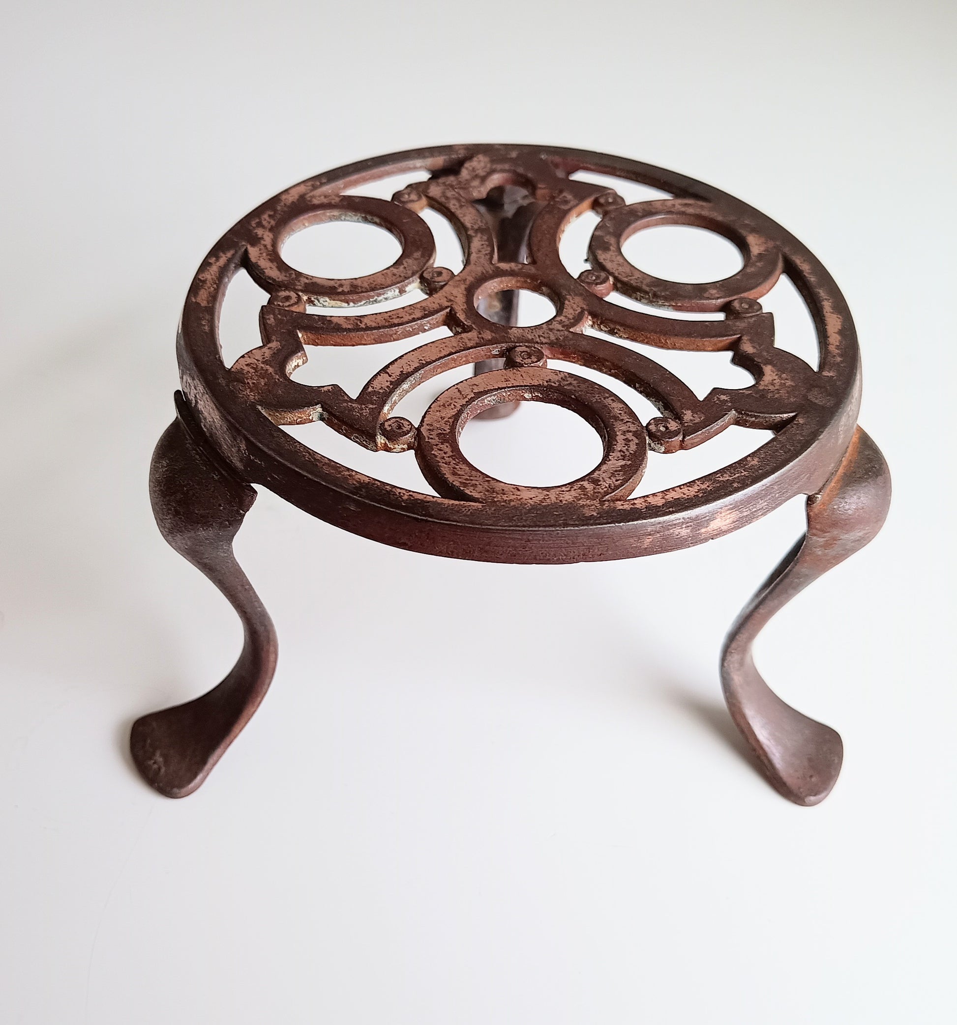 Decorative cast iron trivet with intricate design Art Nouveau 