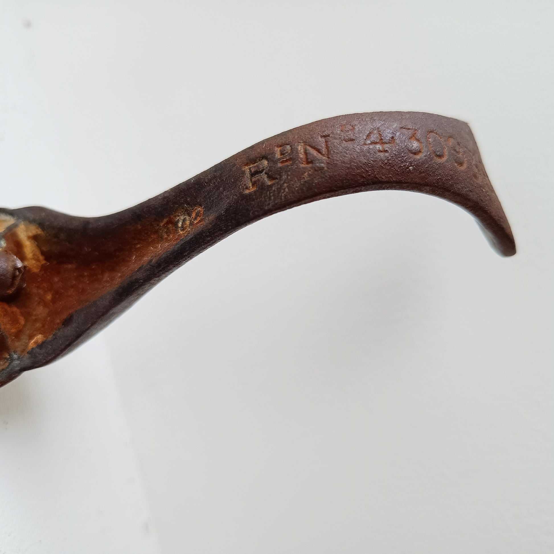 Close-up of cast iron stand with engraved Registered design 